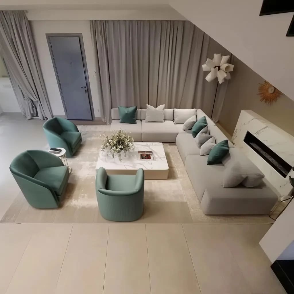 The centerpiece of this design is a marble-inspired coffee table with a rectangular structure, perfectly aligning with the modern minimalistic approach