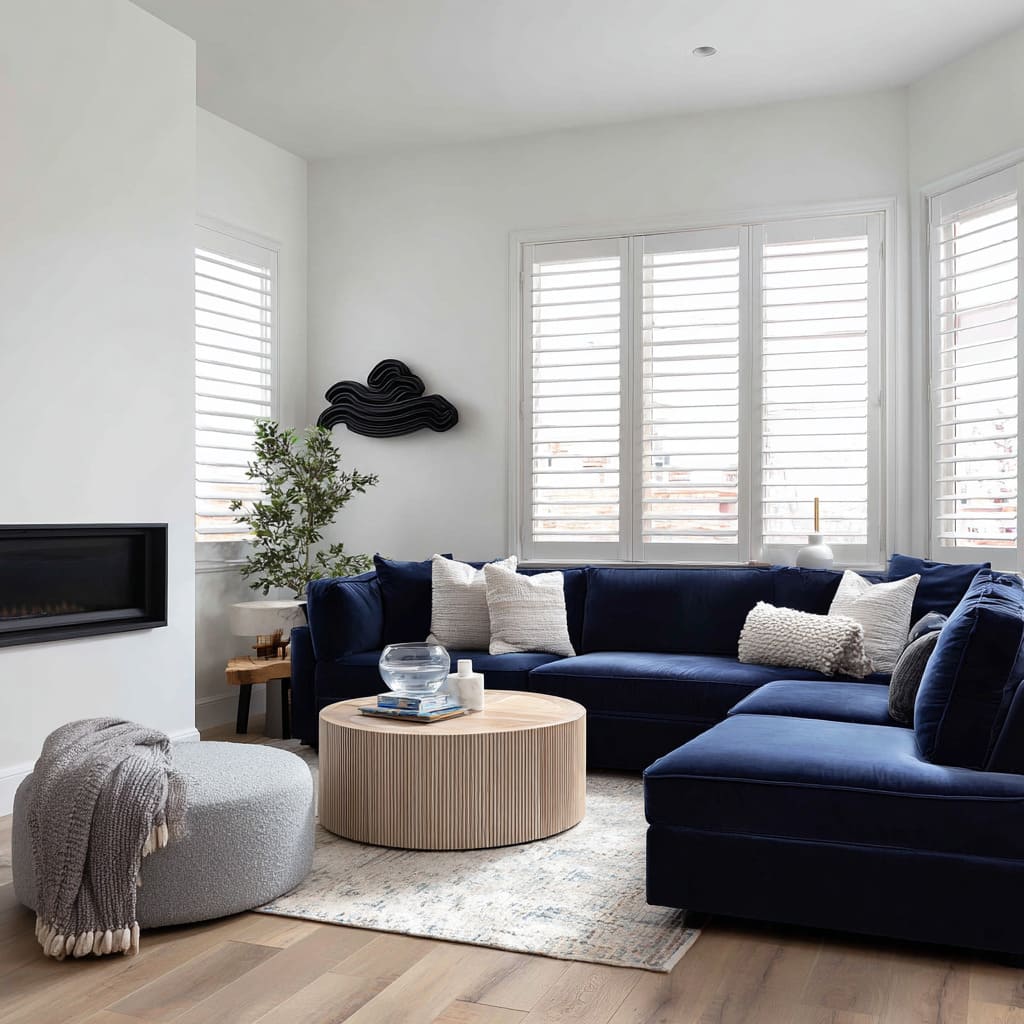 Saturated midnight-blue sectional in a bright corner design with clean whites and sculptural softness Saturated midnight-blue sectional in a bright corner design with clean whites and sculptural softness